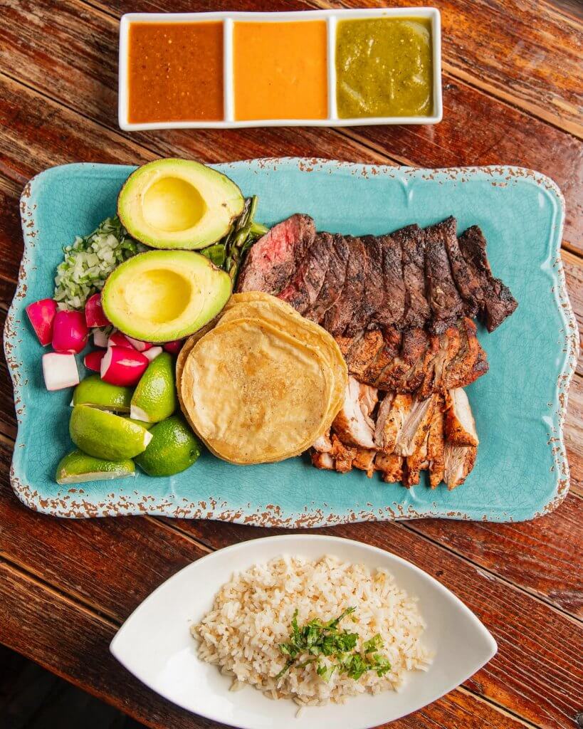 Oaxacan Market (pictured for 2)
grilled skirt steak . marinated chicken thighs . roasted pork . roasted chiles. charred scallions . assorted salsas . ripe avocado . corn tortillas . fresh limes . toasted garlic rice . chopped onion & cilantro